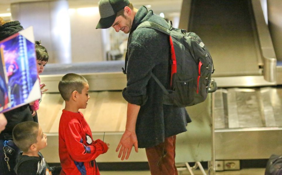 andrew-greeted-young-fan-lax-airport-january-2014