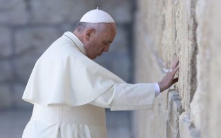 epa04447263 YEARENDER 2014 MAY
Pope Francis bows his head in prayer after placing a written note into a crevice in the Western Wall, Judaism's holiest site, in Jerusalem, Israel, 26 May 2014. Pope Francis prayed at the Western Wall, the only standing remnant of the platform that once housed the Jewish Temple, in the Old City of Jerusalem amid heavy security.  EPA/JIM HOLLANDER
