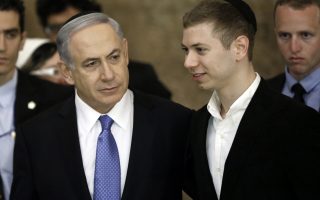 TOPSHOTSIsraeli Prime Minister Benjamin Netanyahu (L) and his son Yair visit, on March 18, 2015, the Wailing Wall in Jerusalem following his party Likud's victory in Israel's general election. Netanyahu swept to a stunning election victory, securing a third straight term for an Israeli leader who has deepened tensions with the Palestinians and infuriated key ally Washington.  AFP PHOTO / THOMAS COEX