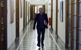 Greece's Finance Minister Yanis Varoufakis arrives for an inner meeting at the parliament in Athens on Tuesday, Feb. 24, 2015. Caught between its campaign pledges and pressure from creditors, Greece's left-wing Syriza government delivered the list on the cusp of Monday night's deadline. The government was asked to present a list last Friday at a meeting of the 19 finance ministers of the eurozone so its bailout request could be met. (AP Photo/Thanassis Stavrakis)