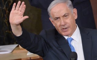 (FILES) - A file picture taken on  March 3, 2015 shows Israel's Prime Minister Benjamin Netanyahu waves following his address to a joint session of the US Congress at the US Capitol in Washington, DC.  Netanyahu on Sunday again denounced the agreement between Tehran and world powers as a 