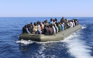 Illegal migrants, who attempted to flee the coast to Europe, travel in a boat after they were detained by the Libyan coastguard in Garbouli June 5, 2014. Libya's coastguard picked up over 100 immigrants in its waters to the west of Tripoli on Thursday, Libyan coast guards officials said. The 114 men, mostly from Senegal, were detained as they were trying to cross to Europe in a small boat.  REUTERS/Hani Amara (LIBYA - Tags: SOCIETY IMMIGRATION CIVIL UNREST CRIME LAW MARITIME)