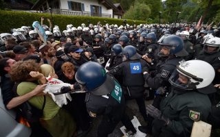 epa04786237 Protestors and German police officers clash during a protest against the G7 summit in Garmisch-Partenkirchen, Germany, 06 June 2015. Heads of state and government of the seven leading industrialized nations (G7) are scheduled to meet in Elmau Castle, Bavaria, on 07 and 08 June as the climax of Germany's presidency of the G7.  EPA/BORIS ROESSLER
