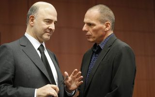 epa04654894 EU Commissioner in charge of Economic and Financial Affairs, Taxation and Customs Union, Pierre Moscovici  (L) and Greek Finance Minister Yanis Varoufakis  at the start of the Eurogroup meeting of Finance ministers at the EU council headquarters, in Brussels, Belgium, 09 March 2015. The Eurogroup will discuss the current situation in Greece.  EPA/OLIVIER HOSLET