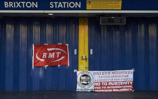 (Files) In this file picture taken on July 9, 2015, Union banners are seen on display outside the closed gates of Brixton underground station during a tube strike in London. London's Underground network will shut down this week for the second time in two months after talks again broke down in a dispute over all night services, trade unions said Monday. AFP PHOTO / NIKLAS HALLE'N