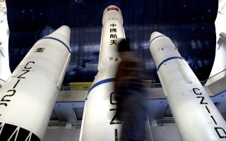 A Chinese man walks past Long March rockets on display in Beijing October 12, 2003. The Long March rocket is the vehicle for China's space programme. China is counting down to its first manned space flight, scheduled for sometime between October 15 and 17.   REUTERS/Guang Niu