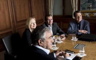 Turkish Cypriot leader Mustafa Akinci, left, speaks with Greek Cypriot President Nicos Anastasiades, right, next to Special Adviser to the United Nations Secretary-General on Cyprus Espen Barth Eide, 2nd right, and Elizabeth Spehar, Deputy to the Secretary-General's Special Adviser on Cyprus, 2nd left, during the Cyprus Talks, in Mont Pelerin, Switzerland Sunday, Nov. 20, 2016. (Jean-Christophe Bott/Keystone via AP)