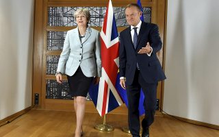 British Prime Minister Theresa May, left, walks with European Council President Donald Tusk prior to a meeting at the Europa building in Brussels on Friday, Dec. 8, 2017. British Prime Minister Theresa May, met with EU officials early Friday morning following crucial overnight talks on the issue of the Irish border. (AP Photo/Geert Vanden Wijngaert)