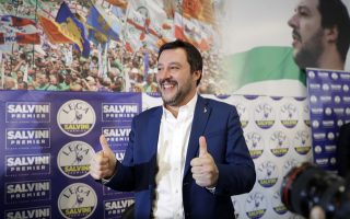 Right-wing, anti-immigrant and euroskeptic League's Matteo Salvini gives the thumbs up at the end of a press conference on the preliminary election results, in Milan, Monday, March 5, 2018. The League jumped from 4 percent of the vote five years ago to nearly 18 percent in Sunday's vote, ahead of Forza Italia, which had nearly 14 percent. (AP Photo/Luca Bruno)