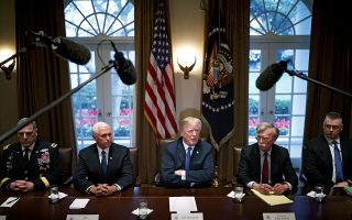 President Donald Trump is flanked by Vice President Mike Pence, left, and National Security Adviser John Bolton as he meets with senior military leaders at the White House in Washington, April 9, 2018. Trump put Syria and Russia on notice April 11 in a Twitter post, promising that missiles fired at Syria Òwill be coming, nice and new and Ôsmart!ÕÓ and telling the Kremlin that it should not partner with a ÒGas Killing Animal who kills his people and enjoys it!Ó After the threat, the president said in a separate tweet that relations between the U.S. and Russia are worse than ever. (Tom Brenner/The New York Times)