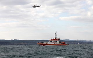 A Turkish coastguard boat and helicopter search for possible survivors near the remains of a boat carrying suspected migrants from Afghanistan and Syria that sank just north of the Bosphorus Strait off the coast of Istanbul, Turkey, Monday, Nov. 3, 2014, leaving at least 24 people dead and several people missing. Seven people were rescued, Turkish authorities said.(AP Photo)