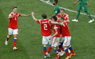 Russian players celebrate their side fifth goal against Saudi Arabia during the opening match of the 2018 soccer World Cup at the Luzhniki stadium in Moscow, Russia, Thursday, June 14, 2018. (AP Photo/Victor Caivano)