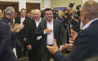 Macedonia's Prime Minister Zoran Zaev is applauded as he arrives to give a statement to members of the media about the referendum in Skopje, Macedonia, Sunday, Sept. 30, 2018. The crucial referendum on accepting a deal with Greece to change the country's name to North Macedonia to pave the way for NATO membership attracted tepid voter participation Sunday, a blow to Zaev's hopes for a strong message of support. (AP Photo/Boris Grdanoski)