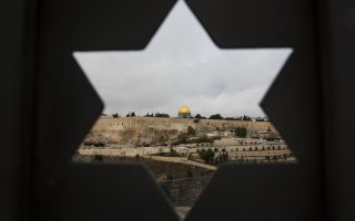 Jerusalem Old City is seen trough a door with the shape of star of David, in Jerusalem, Wednesday, Dec. 6, 2017. U.S. officials say President Donald Trump will recognize Jerusalem as Israel's capital Wednesday, Dec. 6, and instruct the State Department to begin the multi-year process of moving the American embassy from Tel Aviv to the holy city. His decision could have deep repercussions across the region. (AP Photo/Oded Balilty)
