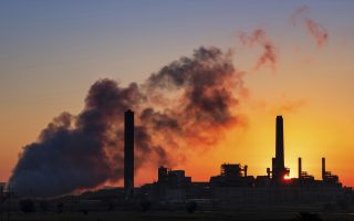 In this July 27, 2018, photo the Dave Johnson coal-fired power plant is silhouetted against the morning sun in Glenrock, Wyo. (AP Photo/J. David Ake)