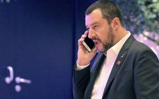 Italy Interior minister Matteo Salvini phones before the start of the of the EU conference on security and migration in Vienna, Austria, Friday, Sept. 14, 2018. (AP Photo/Ronald Zak)