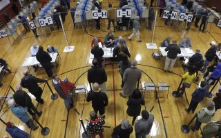 Voters wait in line in the gymnasium at Brunswick Junior High School to receive their ballots for the mid-term election, Tuesday, Nov. 6, 2018, in Brunswick, Maine. (AP Photo/Robert F. Bukaty)