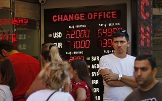People line up at a currency exchange shop in Istanbul, Tuesday, Aug. 14, 2018.The Turkish lira has nosedived in value in the past week over concerns about Erdogan's economic policies and after the United States slapped sanctions on Turkey angered by the continued detention of an American pastor. (AP Photo/Lefteris Pitarakis)
