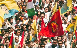 Thousands of Kurds, waving a Kurdish Workers Party  (PKK) flag, foreground right, and portraits of jailed Kurdish PKK leader Abdullah Ocalan, take part to a demonstration, asking for the liberation of Ocalan in Strasbourg, eastern France, Wednesday, June 9, 2004. Thousands of Kurds from France, Germany, Belgium, The Netherlands and Switzerland gathered Wednesday for a march through the city, the 5th since Ocalan was captured and jailed in 1999. (AP Photo/Cedric Joubert)