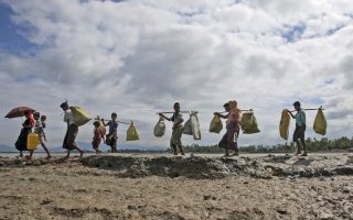Rohingya Muslims, who crossed over from Myanmar into Bangladesh, walk towards a refugee camp in Shah Porir Dwip, Bangladesh, Thursday, Sept. 14, 2017. Nearly three weeks into a mass exodus of Rohingya fleeing violence in Myanmar, thousands were still flooding across the border Thursday in search of help and safety in teeming refugee settlements in Bangladesh. (AP Photo/Dar Yasin)