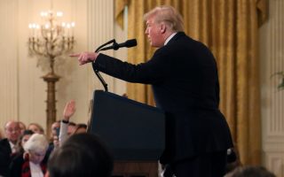A White House staff member reaches for the microphone held by CNN's Jim Acosta as he questions U.S. President Donald Trump during a news conference following Tuesday's midterm U.S. congressional elections at the White House in Washington, U.S., November 7, 2018. REUTERS/Jonathan Ernst     TPX IMAGES OF THE DAY
