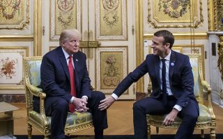 French President Emmanuel Macron, right, puts his hands on U.S President Donald Trump's knee before their talks at the Elysee Palace in Paris, Saturday, Nov.10 2018. Trump is joining other world leaders at centennial commemorations in Paris this weekend to mark the end of World War I. (Christophe Petit Tesson, Pool via AP)