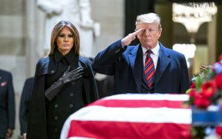 epaselect epa07207368 US President Donald J. Trump (R) and his wife, Melania (L), pay respects to former President George H.W. Bush as he lies in state in the Rotunda of the US Capitol in Washington, DC, USA, 03 December 2018. George H.W. Bush, the 41st President of the United States (1989-1993), died at the age of 94 on 30 November 2018 at his home in Texas.  EPA/JIM LO SCALZO