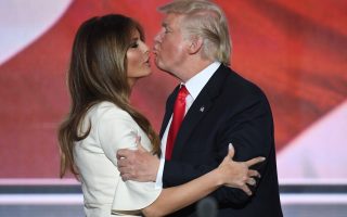 (FILES) This file photo taken on July 22, 2016 shows US Republican presidential candidate Donald Trump kissing his wife Melania on the final night of the Republican National Convention at the Quicken Loans Arena in Cleveland, Ohio.  Donald Trump said on November 9, 2016 he would bind the nation's deep wounds and be a president 