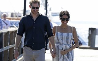 Britain's Prince Harry and Meghan, Duchess of Sussex walk along Kingfisher Bay Jetty during a visit to Fraser Island, Australia, Monday, Oct. 22, 2018. Prince Harry and his wife Meghan are on day seven of their 16-day tour of Australia and the South Pacific. (AP Photo/Kirsty Wigglesworth, Pool)