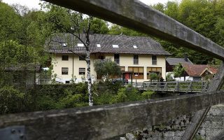 A guesthouse is pictured at the river 'Ilz' in Passau, Germany, Monday, May 13, 2019. Police investigating the mysterious death of three people whose bodies were found with crossbow bolts inside at the hotel in Bavaria on Saturday, May 11, 2019. (AP Photo/Matthias Schrader)