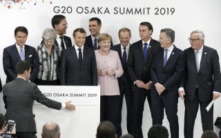 Leaders from left to right, Italian Prime Minister Giuseppe Conte, British Prime Minister Theresa May, Mark Rutte, Prime Minister of the Netherlands, French President Emmanuel Macron, Spanish Prime Minister Pedro Sanchez, German Chancellor Angela Merkel, Donald Tusk, President of the European Council, Brazil's President Jair Bolsonaro, Argentina President Mauricio Macri and European Commission President Jean-Claude Juncker prepare to attend a press conference at the venue of the G-20 summit in Osaka, western Japan Saturday, June 29, 2019. (AP Photo/Eugene Hoshiko)