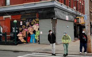 FILE PHOTO: Pedestrians wearing masks walk in front of shuttered buildings as the spread of the coronavirus disease (COVID-19) outbreak continues in the Brooklyn borough of New York City, U.S., April 27, 2020. REUTERS/Lucas Jackson/File Photo