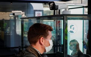 A passenger wearing a face mask walks past thermic cameras at the Zaventem International Airport, as Belgium eases restrictions aimed to contain the spread of the coronavirus disease (COVID-19) outbreak, near Brussels, Belgium June 15, 2020. REUTERS/Francois Lenoir