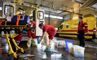 Medical staff members of M2 Ambulance company wear their protective suits as they prepare before the transport of a patient infected with the coronavirus disease (COVID-19) in Ottignies, Belgium, October 23, 2020. REUTERS/Johanna Geron