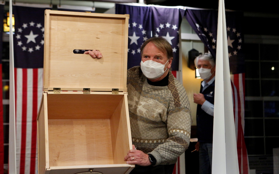 Town moderator Tom Tillotson shows an empty box for ballots for the U.S. presidential election at the Hale House at Balsams Hotel in the hamlet of Dixville Notch, New Hampshire, U.S., November 3, 2020. REUTERS/Ashley L. Conti