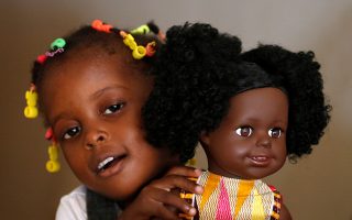 Aremou Karima, 3, holds a doll named Lola of Naima Dolls brand in Abidjan, Ivory Coast December 20, 2020. Picture taken December 20, 2020. REUTERS/Luc Gnago.