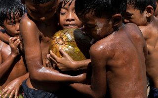 Children play with an oiled coconut during Myanmar's 73rd Independence Day celebrations amid the spread of the coronavirus disease (COVID-19) in Yangon, Myanmar, January 4, 2021. REUTERS/Shwe Paw Mya Tin